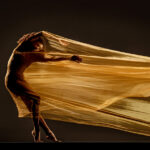 Silhouette of a dancer as she performs with a flowing dress at Appalachian Summer