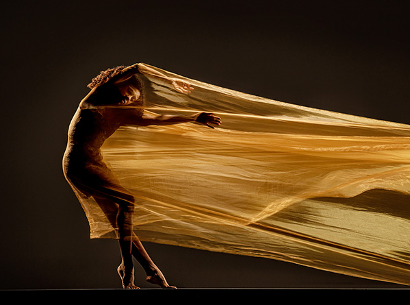 Silhouette of a dancer as she performs with a flowing dress at Appalachian Summer