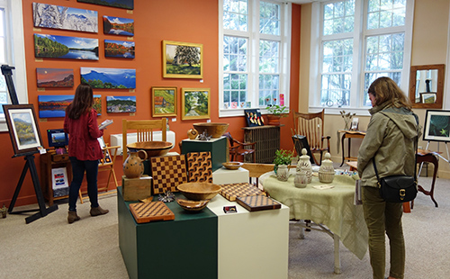 Shoppers browse the artwork at BE Artists Gallery in Banner Elk, NC