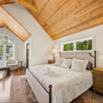 Restored hardwood floors and arched ceiling in this spacious primary bedroom