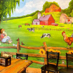 Cozy dining room with farm mural at Bella's Breakfast & Lunch