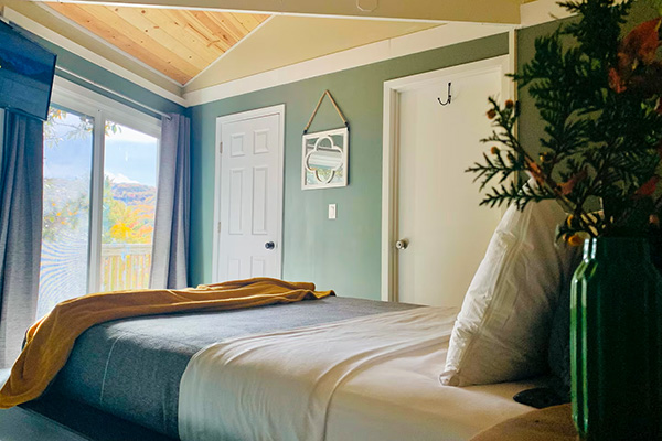 Main bedroom features natural light and mountain views