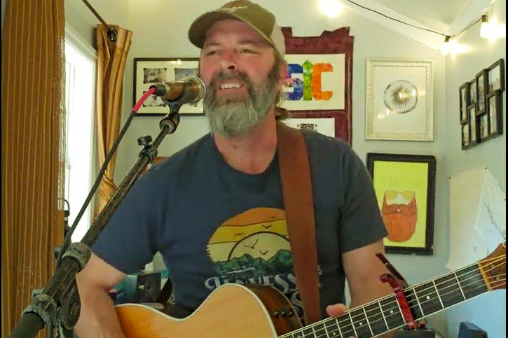 Eric Chesson plays guitar and sings