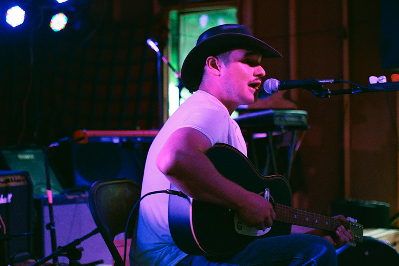 Musician Sam Fanthorpe plays acoustic guitar at a performance near Banner Elk, NC