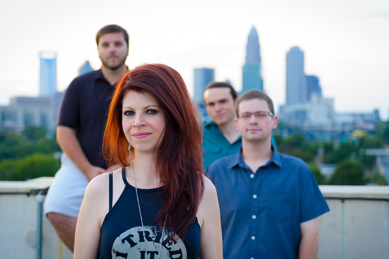 Stella Rising band members with Charlotte skyline in the distance