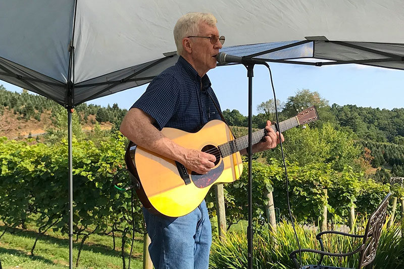 Singer Tom Pillion plays guitar in the vineyards of Banner Elk Winery in Banner Elk NC