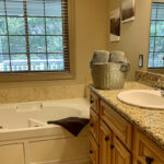 Luxury whirlpool soaking tub and granite counters in the main bedroom