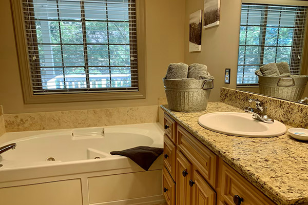 Luxury whirlpool soaking tub and granite counters in the main bedroom