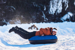 A rider enjoys a fast snow tubing run at Hawksnest snowtubing in North Carolina