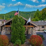 Exterior photo of Lodge at Banner Elk framed by mountains