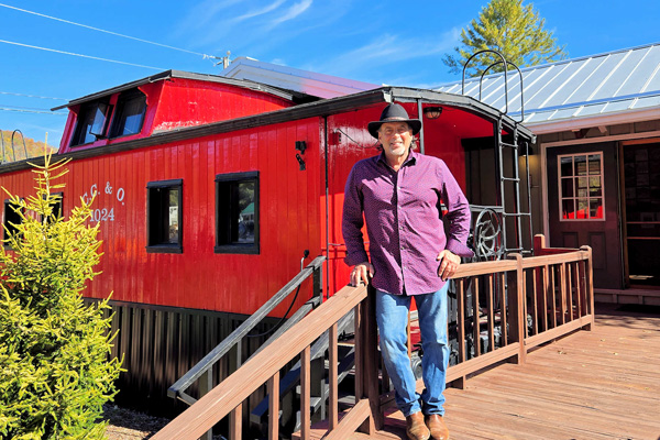 Acclaimed photographer Joseph Nitti stands in front of his red caboose gallery in Banner Elk NC