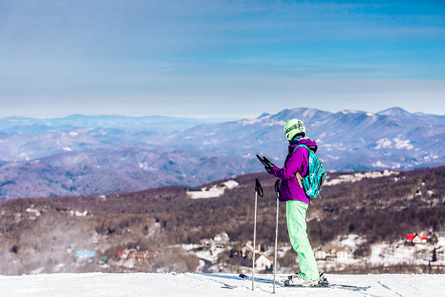 A skier takes in the view from the top of the slopes at Beech Mountain ski resort in North Carolina