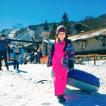 Kid enjoys snow tubing at Beech Mountain Resort near Banner Elk, N. Carolina