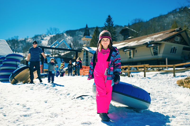 Kid enjoys snow tubing at Beech Mountain Resort near Banner Elk, N. Carolina