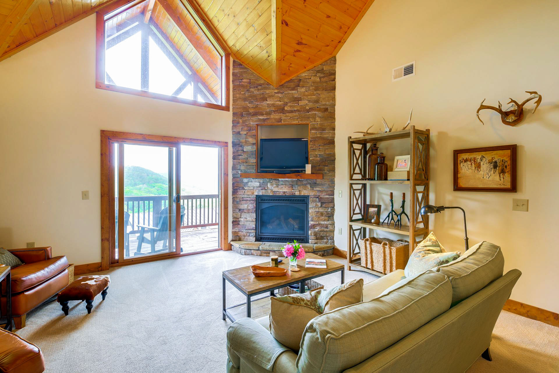 Cathedral ceilings show mountain views in this vacation condo