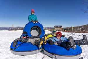 A family enjoys snow tubing in North Carolina at Beech Mountain Resort near Banner Elk