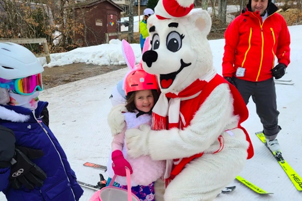 Sugar Bear hugging kid participating in Easter Egg Hunt